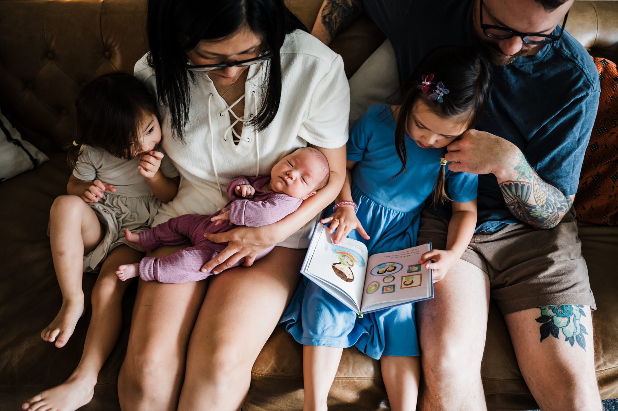 Family spending time together with their newborn baby at home