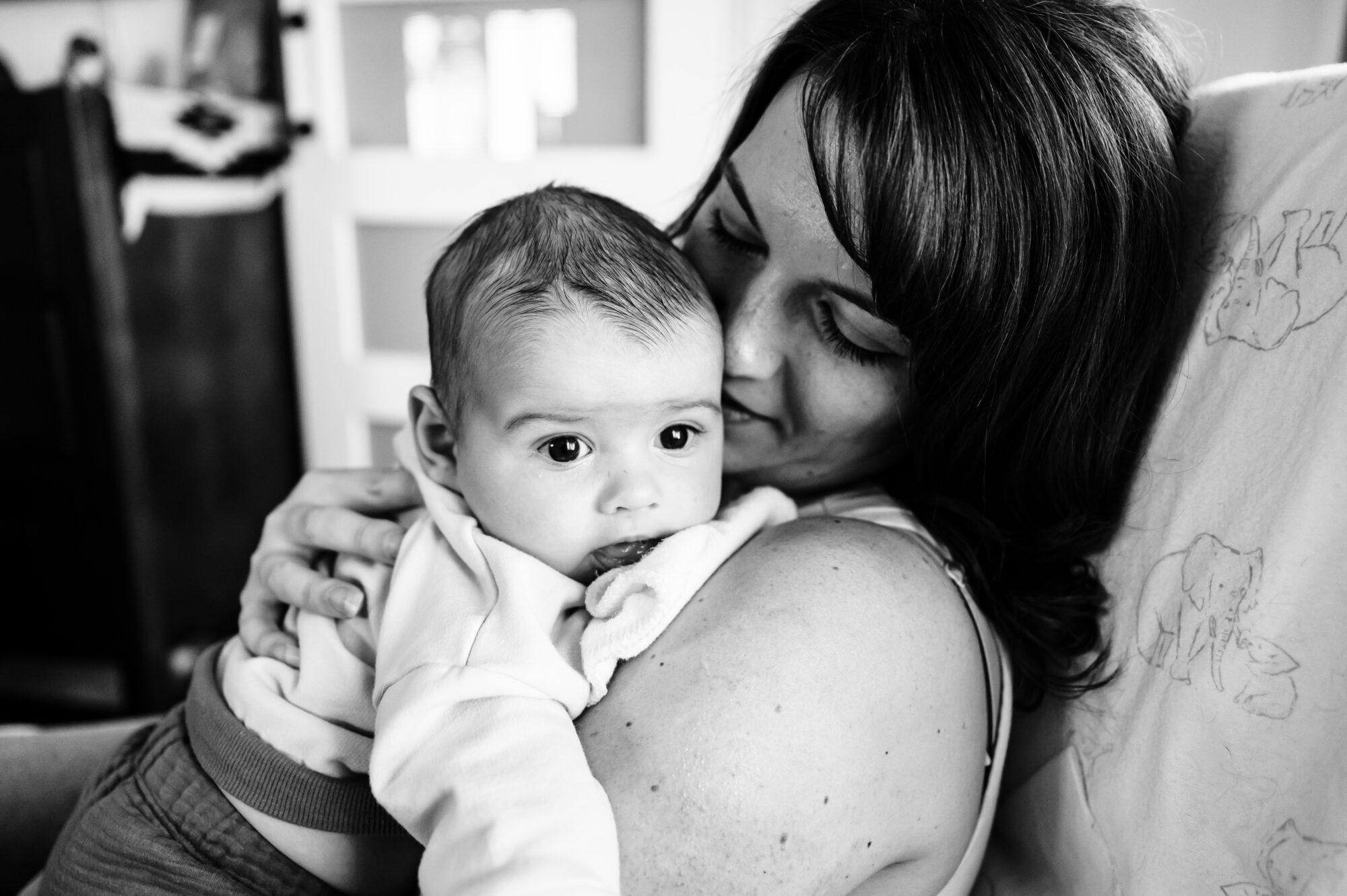 New mom holding her newborn baby at home in San Diego